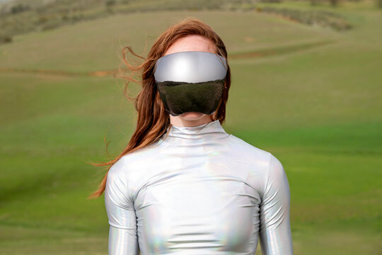 Model with futuristic VR headset and metallic suit outdoors