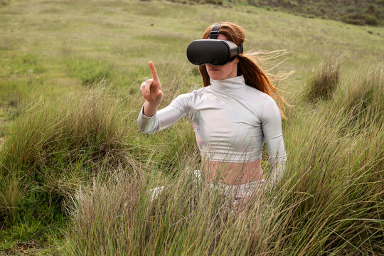 Using virtual reality headset wearing metallic clothes outdoors