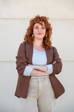 Confident businesswoman with crossed arms outdoors