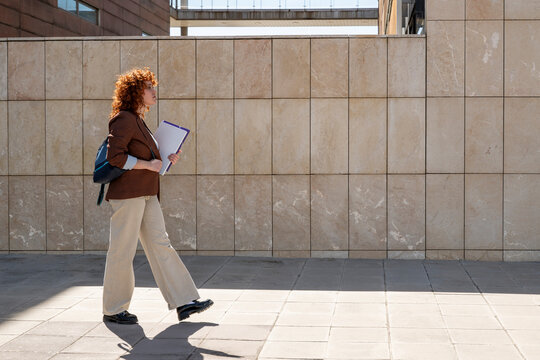 Red haired entrepreneur walking outdoors in Granada