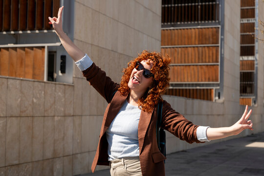 Happy entrepreneur making victory sign outdoors in Granada Spain