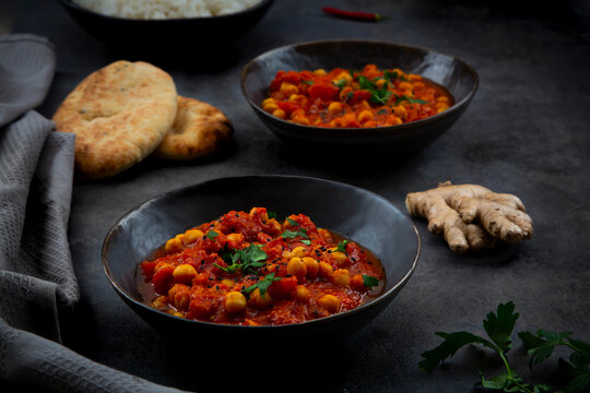 Indian chana masala chickpea curry with naan bread and ginger