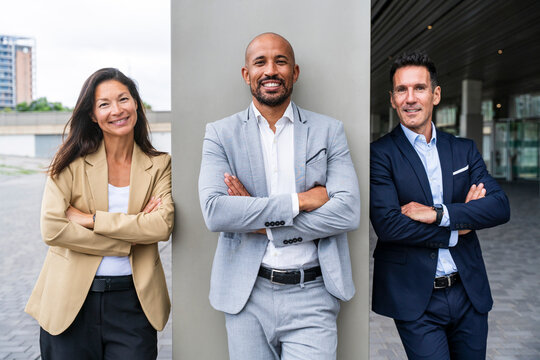 Smiling real estate agents standing outdoors in financial district