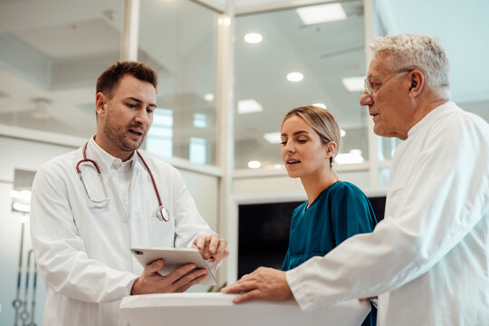 Medical professionals consulting in a doctor's office with a focus on teamwork and experience