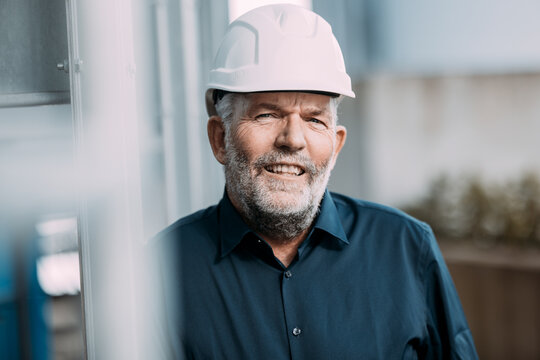 Engineer smiling outdoors wearing a hard hat