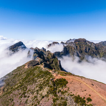 Winding trail on Pico do Arieiro ridge above the clouds