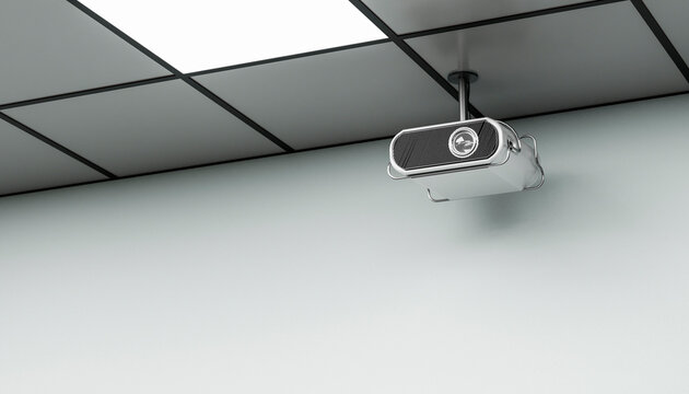 Modern projector mounted on an office ceiling with copy space