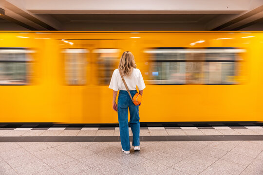 Woman waiting for train at underground station in Berlin