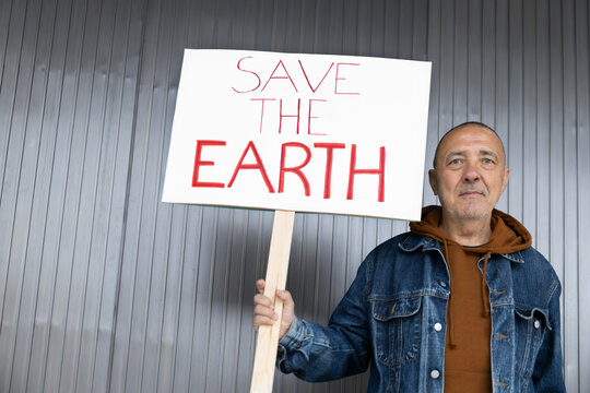 Activist holding save the earth sign for ecology and sustainability