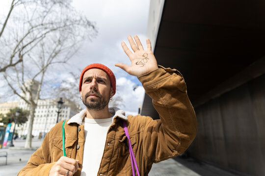 Activist showing stop on hand protesting for future change