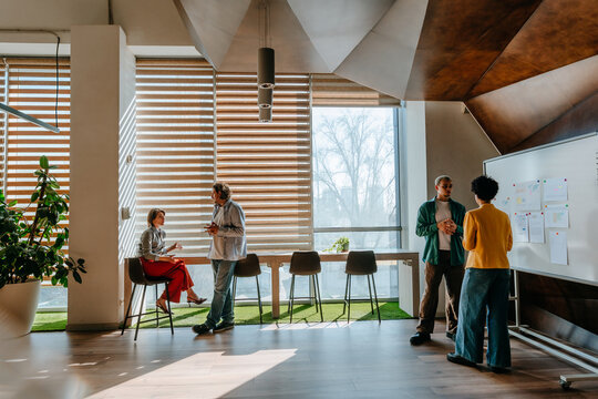 Colleagues discussing and brainstorming in a modern office