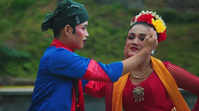 Close-Up Portrait of Male Indonesian Dancer Adjusting Female Dancer's Hair