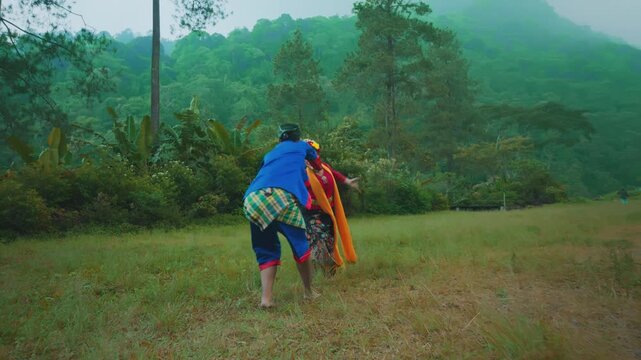 Energetic Dance Performance of Indonesian Couple in Tropical Hillside Setting