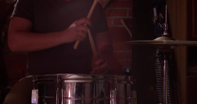 Drummer playing on concert and hit the drum cymbal hi hats, or in studio