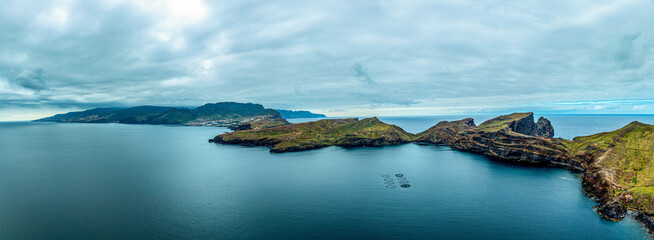 Aerial drone view of the Madeira coastline with steep cliffs, Atlantic Ocean, and natural landscape. Calm travel scene with typical Portuguese island scenery. © coffeinlix 