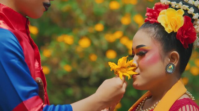 Romantic Scene of Traditional Dancer Giving Flower to Partner