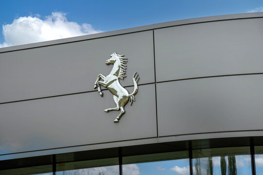 Ferrari horse logo on a Ferrari dealership showroom. Ferrari N.V. is an Italian luxury sports car manufacturer based in Maranello, founded by Enzo Ferrari in 1939.