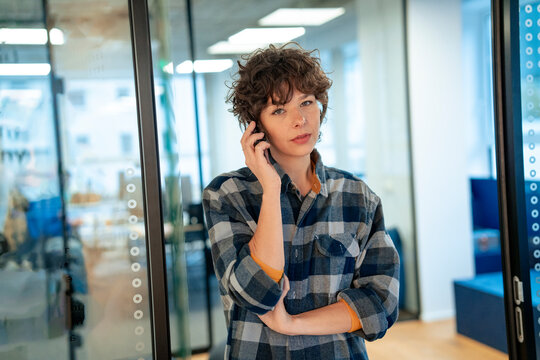 Businesswoman talking on mobile phone in office