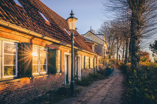 Old brick houses along a path in Hamburg during autumn