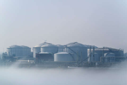 Oil storage tanks in foggy Rotterdam harbour the Netherlands