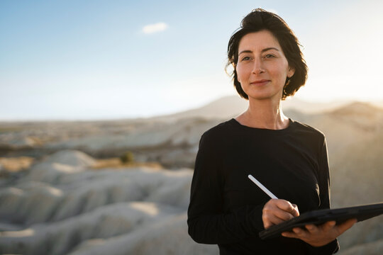 Female architect working remotely on tablet in the desert