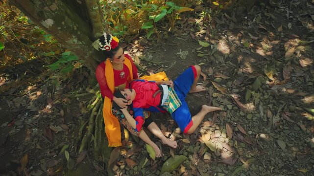 Top View of Traditional Dancer Couple Resting Under Tree