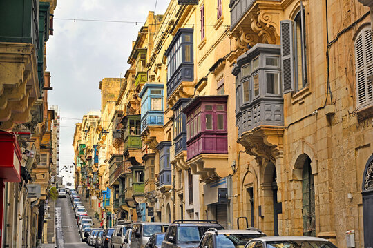 Traditional colorful wooden balconies along the steep St Ursula Street in Valletta Malta
