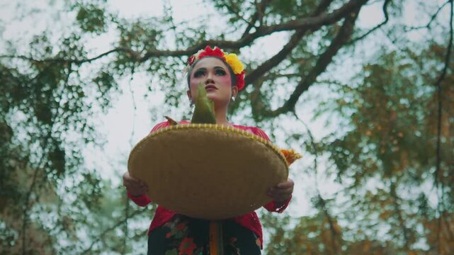 Low Angle of Woman Holding Traditional Offering Tray