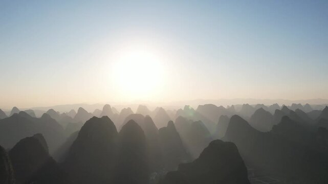 Sunrise over misty karst mountains in Guilin, Guangxi, China
