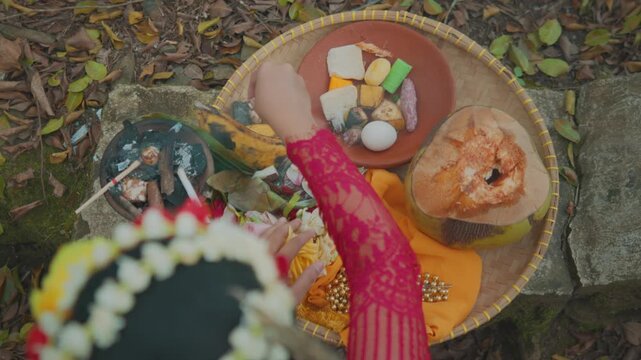 Arranging Food Sacrifices on Bamboo Tray for Ritual