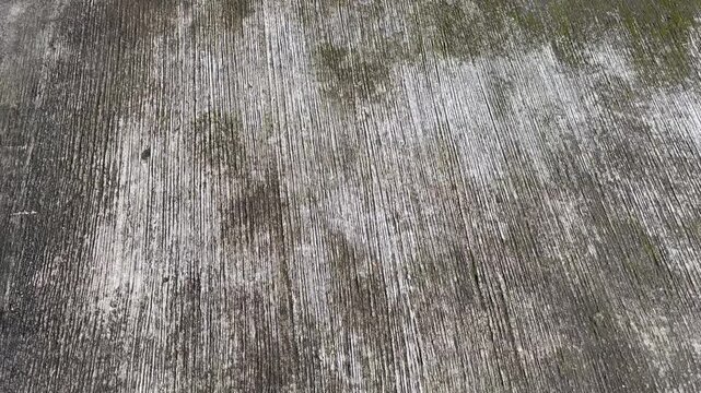 Close up of weathered concrete road surface with grooved texture