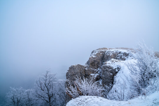 Germany, White snow covered rocks cliffs on breitenstein mountain swabian alb national park nature landscape with fog in winter early morning silence