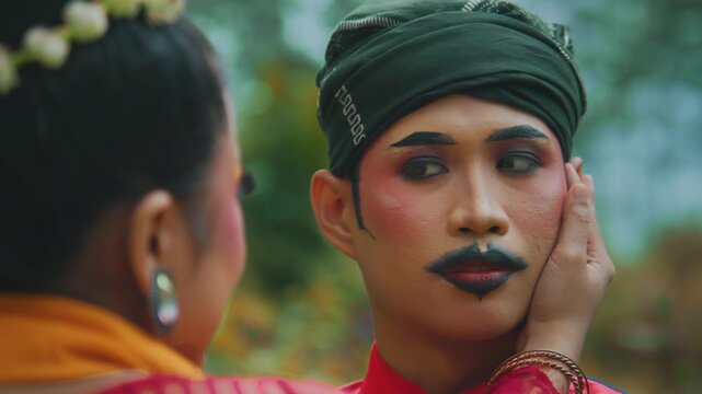 Woman Tenderly Caressing Man's Face with Theatrical Makeup