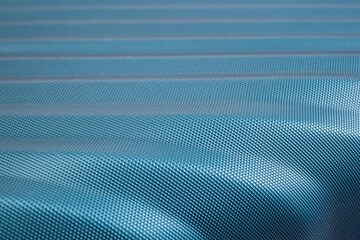 Fototapeta premium Waved turquoise carbon fiber plastic texture, surface detail close up , abstract patterned backdrop wallpaper