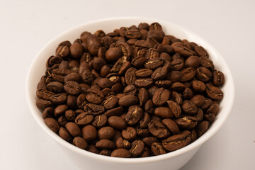 Fototapeta premium Coffee beans on a white background. Top view. Coffee beans texture.