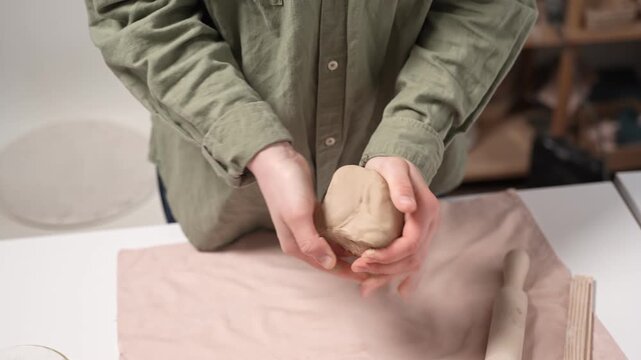 Artisan Kneading Raw Clay by Hand 4K Video Slow Motion. Close-up manual action of clay wedging