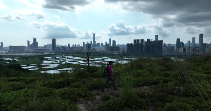 Woman hiking in the Rural green fields in Hong Kong  