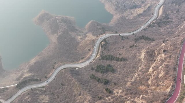 Winding Mountain Road Beside Lake in Dry Hills