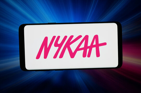 Stuttgart, Germany - 05-13-2026: In this photo illustration, the logo of company FSN E-Commerce Ventures Ltd. (Nykaa) is displayed on a smartphone in front of abstract background on computer screen.