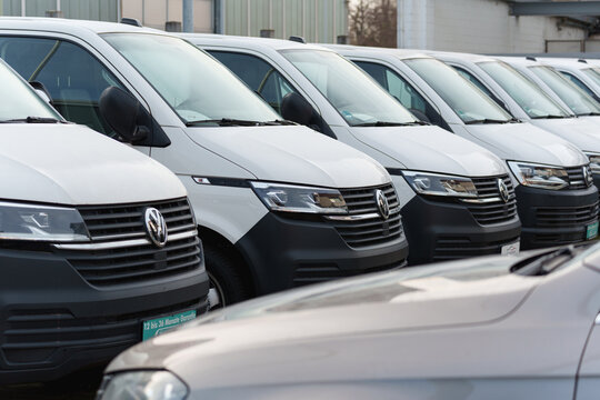 Dusseldorf, Germany - November 22 2025: Row of white Volkswagen vans parked side by side at a commercial vehicle lot