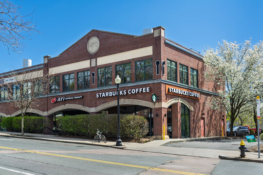 street view of a Brick commercial building with Starbucks Coffee shop on a sunny spring day, on April 24, 2026, Brighton neighborhood of Boston, Massachusetts, USA