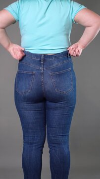 Overweight woman in tight jeans showing love handles and back fat folds, weight loss concept, vertical video