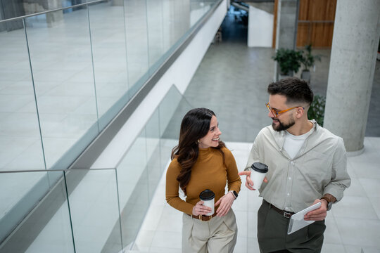 Colleagues collaborating and conversing while walking up stairs