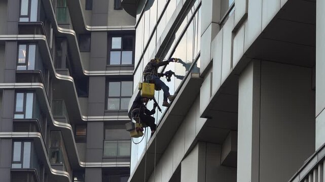 Rope Access Workers Cleaning Modern High-Rise Facade