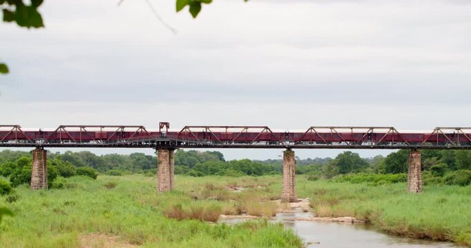 Scenic safari accommodation in Kruger National Park, South Africa. Handheld wide shot of Kruger Shalati luxury train hotel permanently parked on the historic Selati Bridge above Sabie River