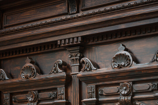 Neo-Baroque carved wooden door detail with ornate floral decorations and wrought iron windows, Odesa Ukraine