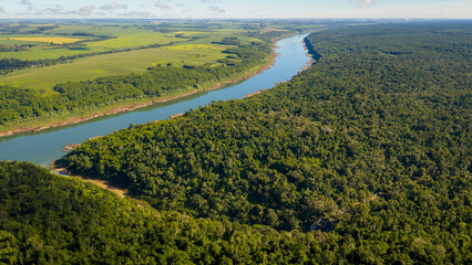 Obraz premium Aerial View of Paraná River Border Showing Landscape Contrast Between Argentina and Paraguay