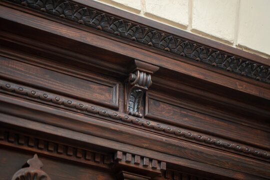 Carved wooden door cornice detail with modillions and ornamental molding, restored historic entrance Odesa Ukraine