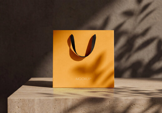 Minimalist Paper Shopping Bag Mockup on Travertine Stone Table with Leaf Shadow Overlay for Premium Retail Branding