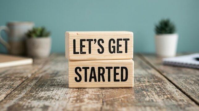 Wooden blocks with the text lets get started on a rustic wooden table